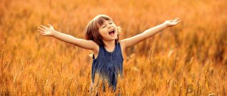 girl spread her arms in a wheat field