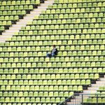 lonely man in a football stadium