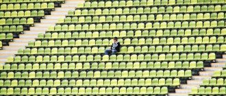 lonely man in a football stadium